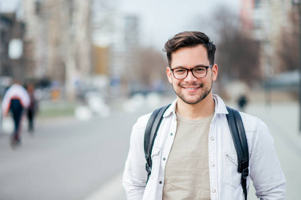 Portrait of a smiling student at the city street